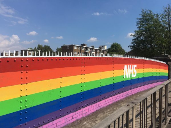 Bridge painted like a rainbow with the NHS logo in the middle to celebrate the hard work of staff during COVID-19