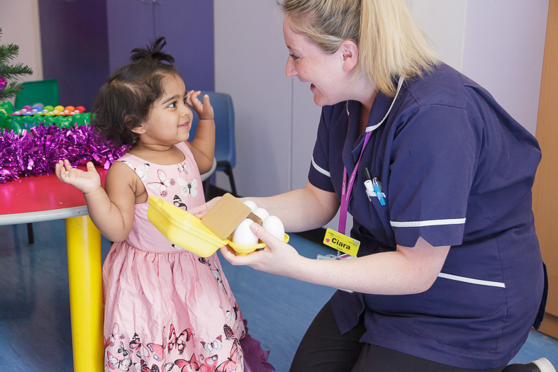 Nurse and young patient play together