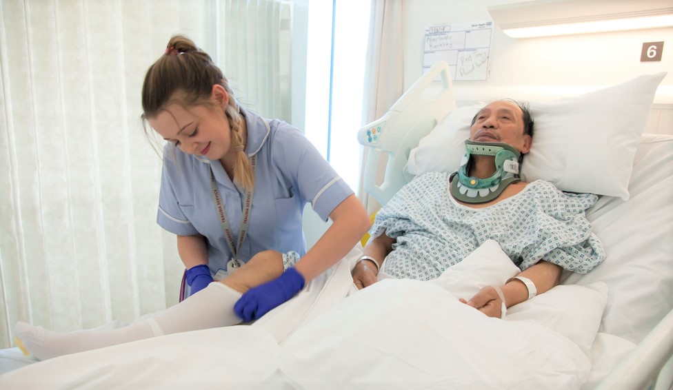 Nurse helping trauma patient at The Royal London Hospital