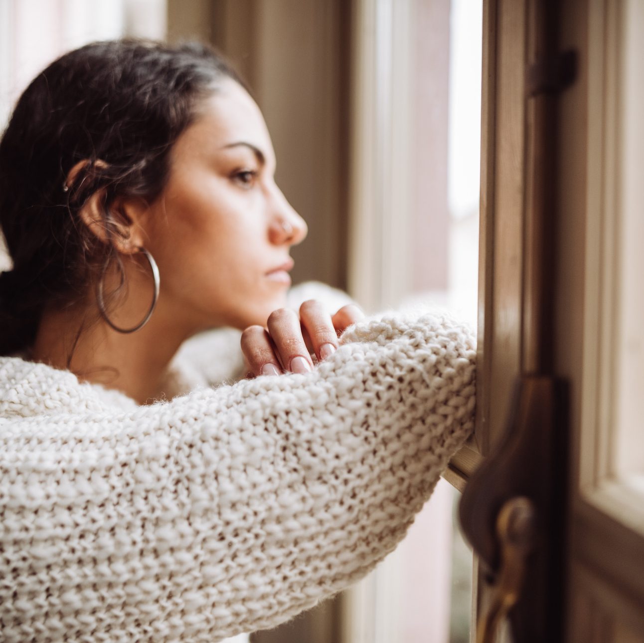 Young woman looking out of the window