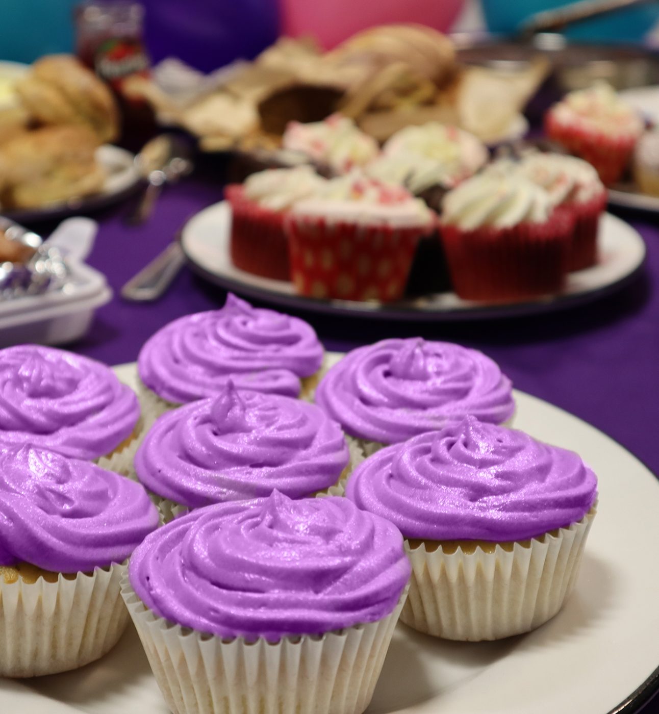 purple cupcakes at a Barts Charity bake sale