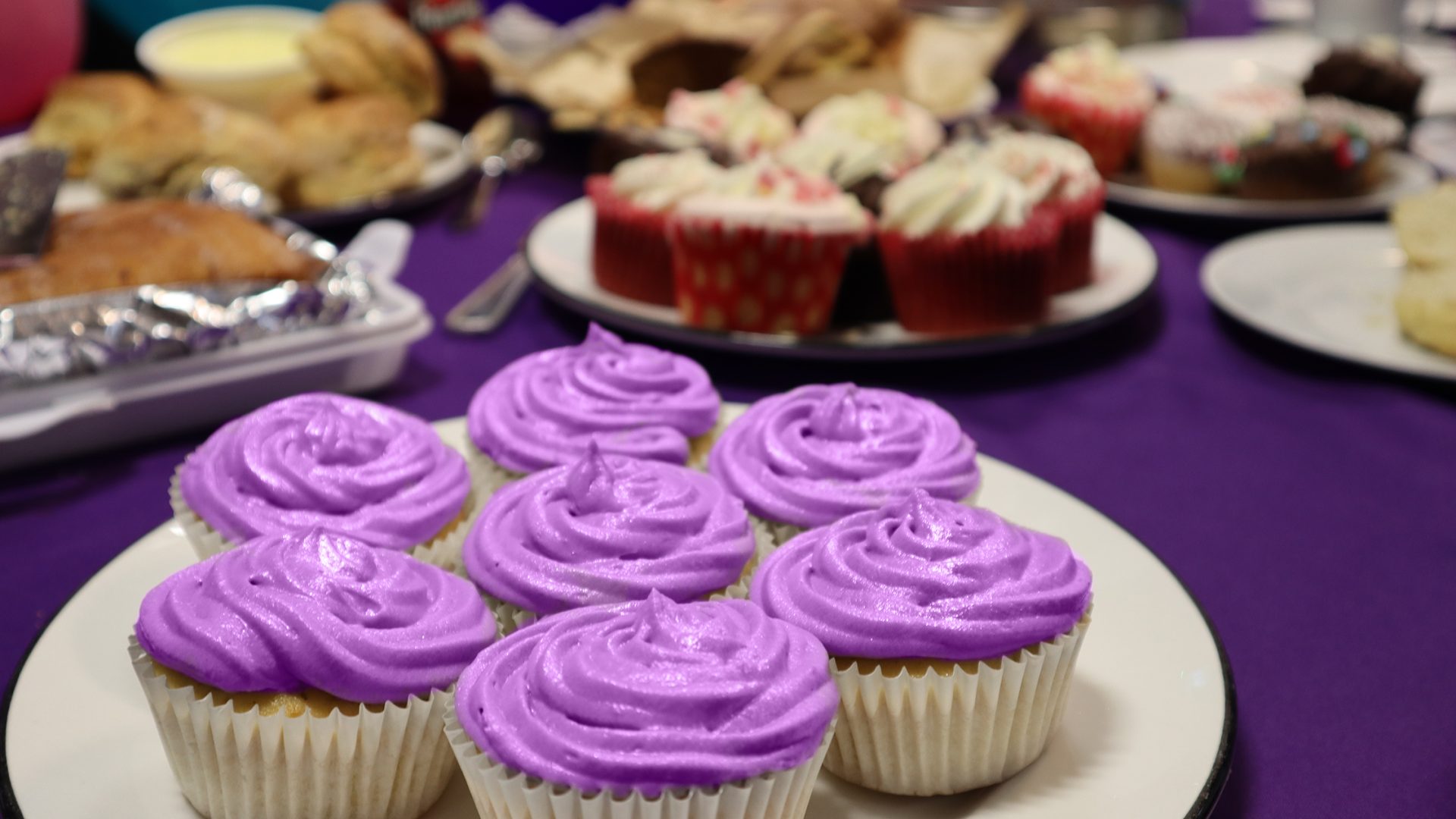 purple cupcakes at a Barts Charity bake sale