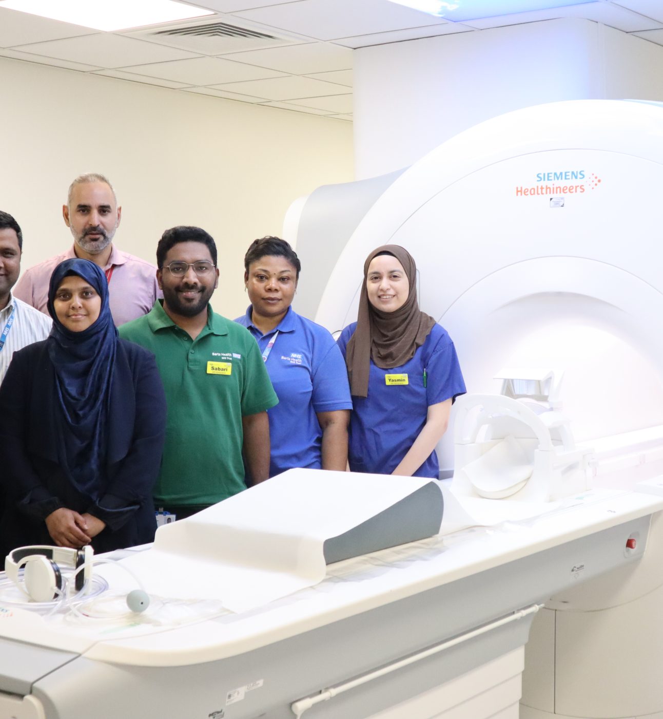 Team stand with the 3T MRI scanner at Mile End Hospital in East London