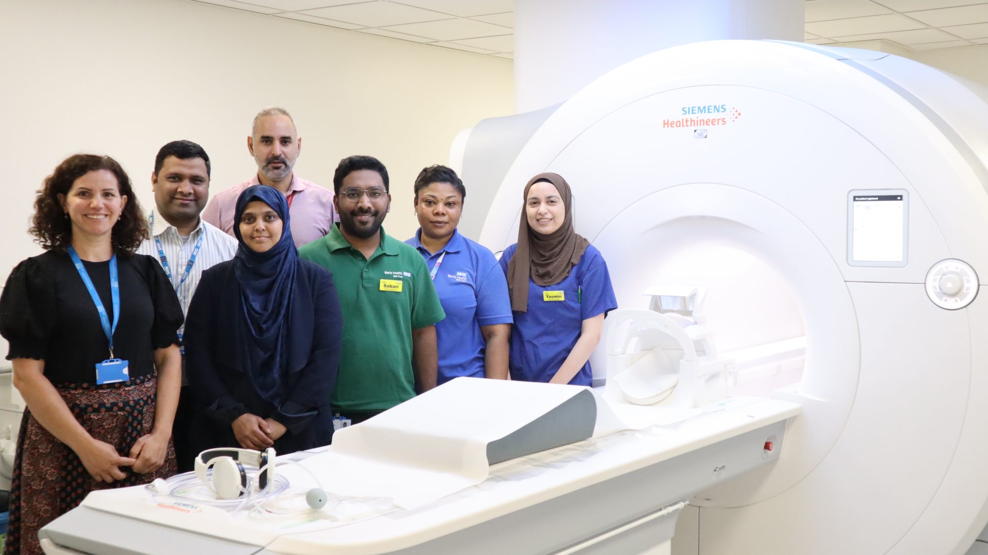 Team stand with the 3T MRI scanner at Mile End Hospital in East London