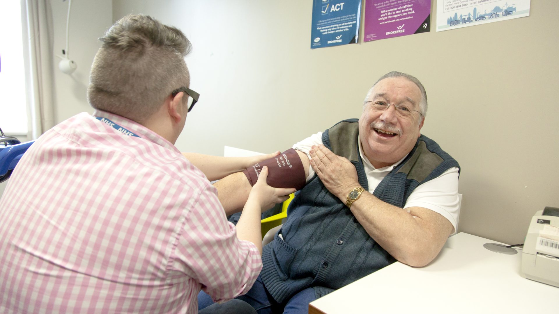 A man has his blood pressure taken by a doctor
