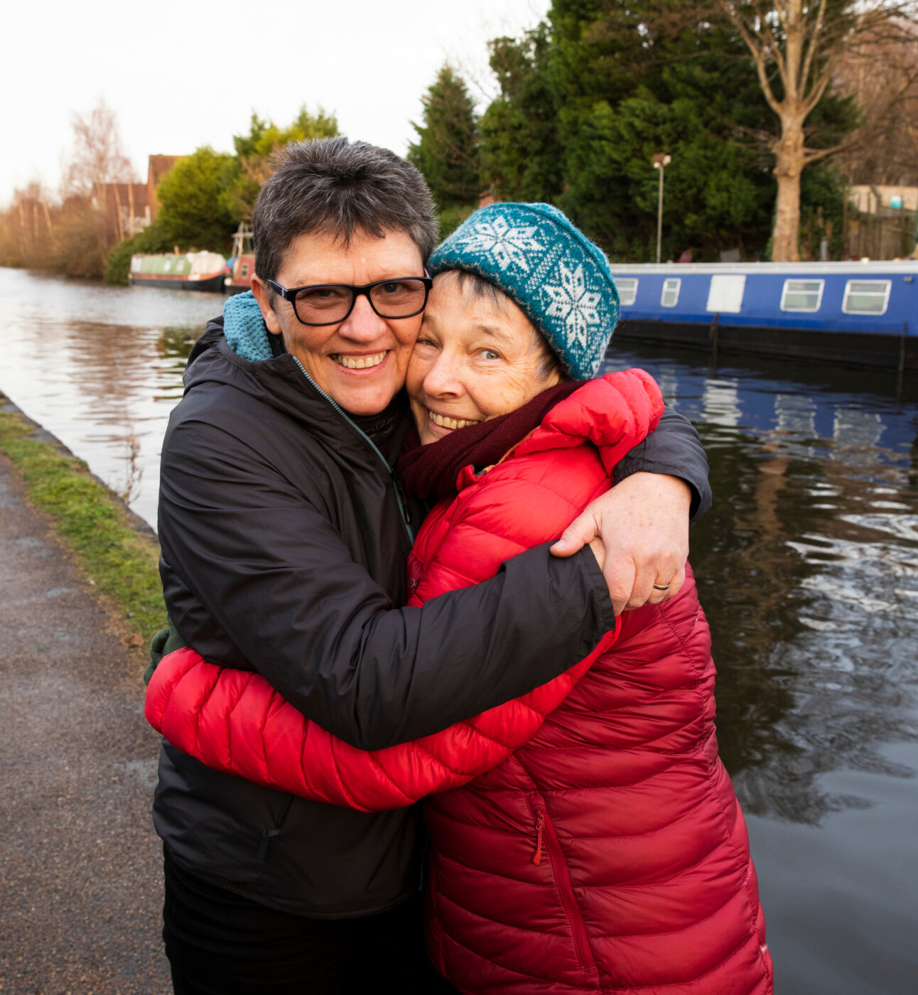 A queer couple on a walk by the canal