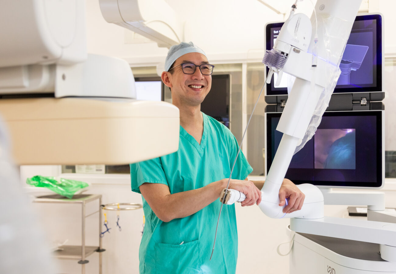 Surgeon Kelvin Lau with robot