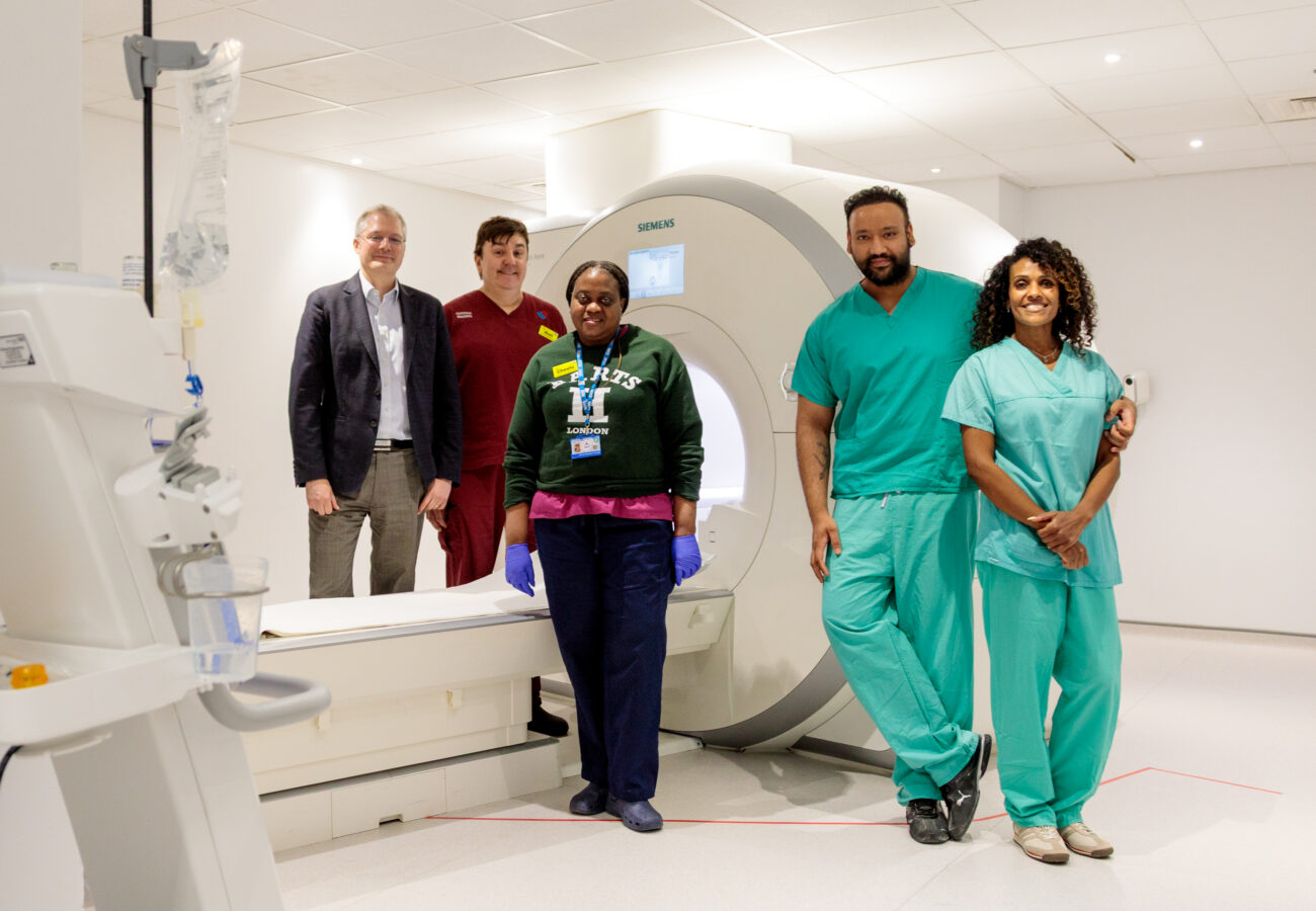 The MRI team at Barts Heart Centre posing with the MRI machine.